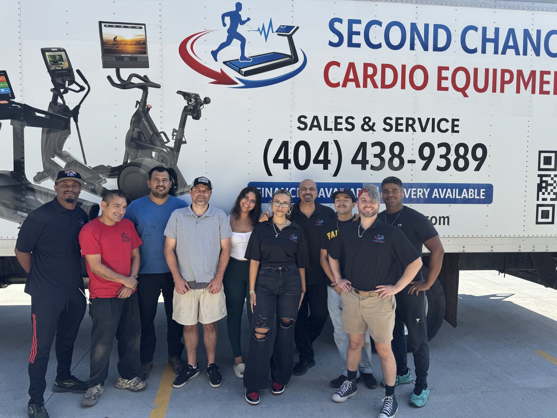 The Second Chance Cardio team beside the branded delivery truck