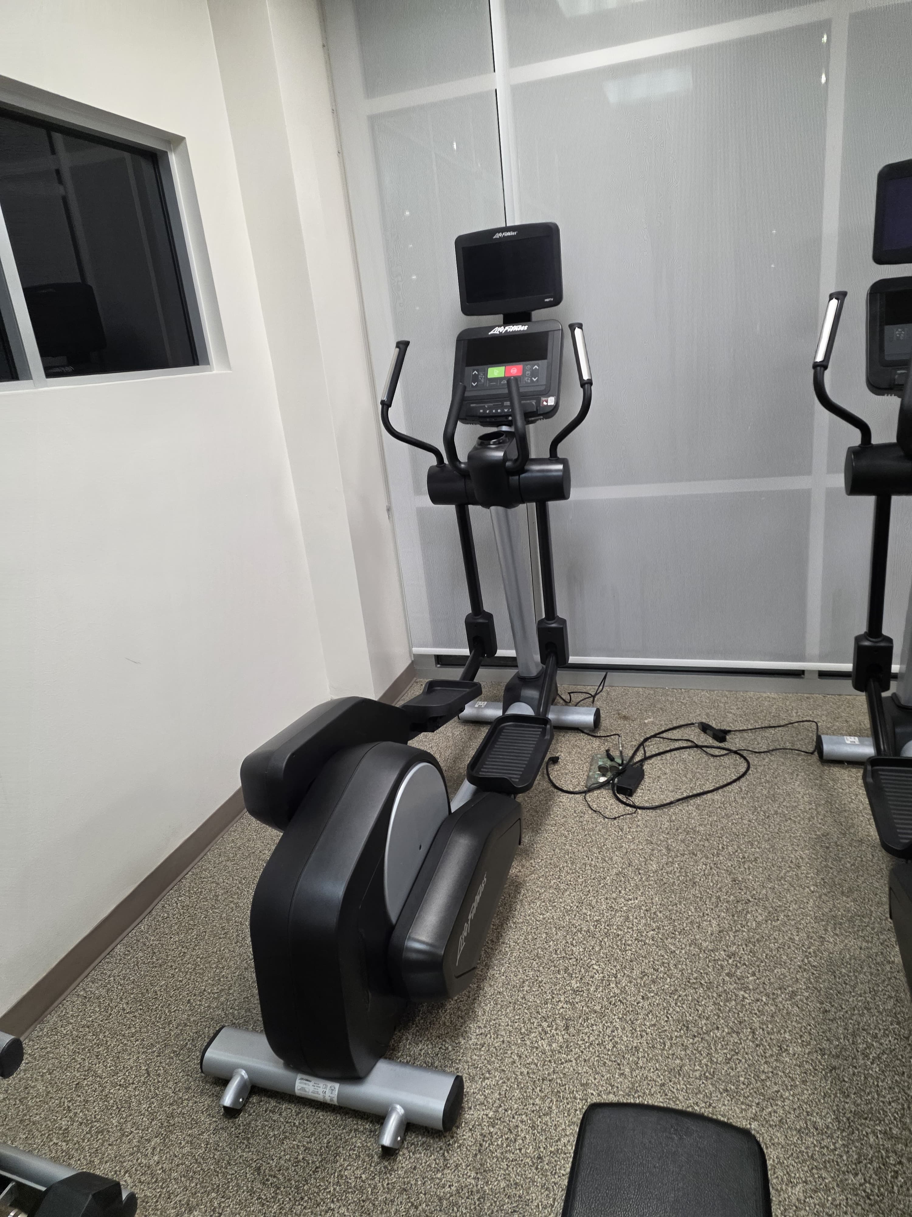 Completed client cardio room with ellipticals and an exercise bike
